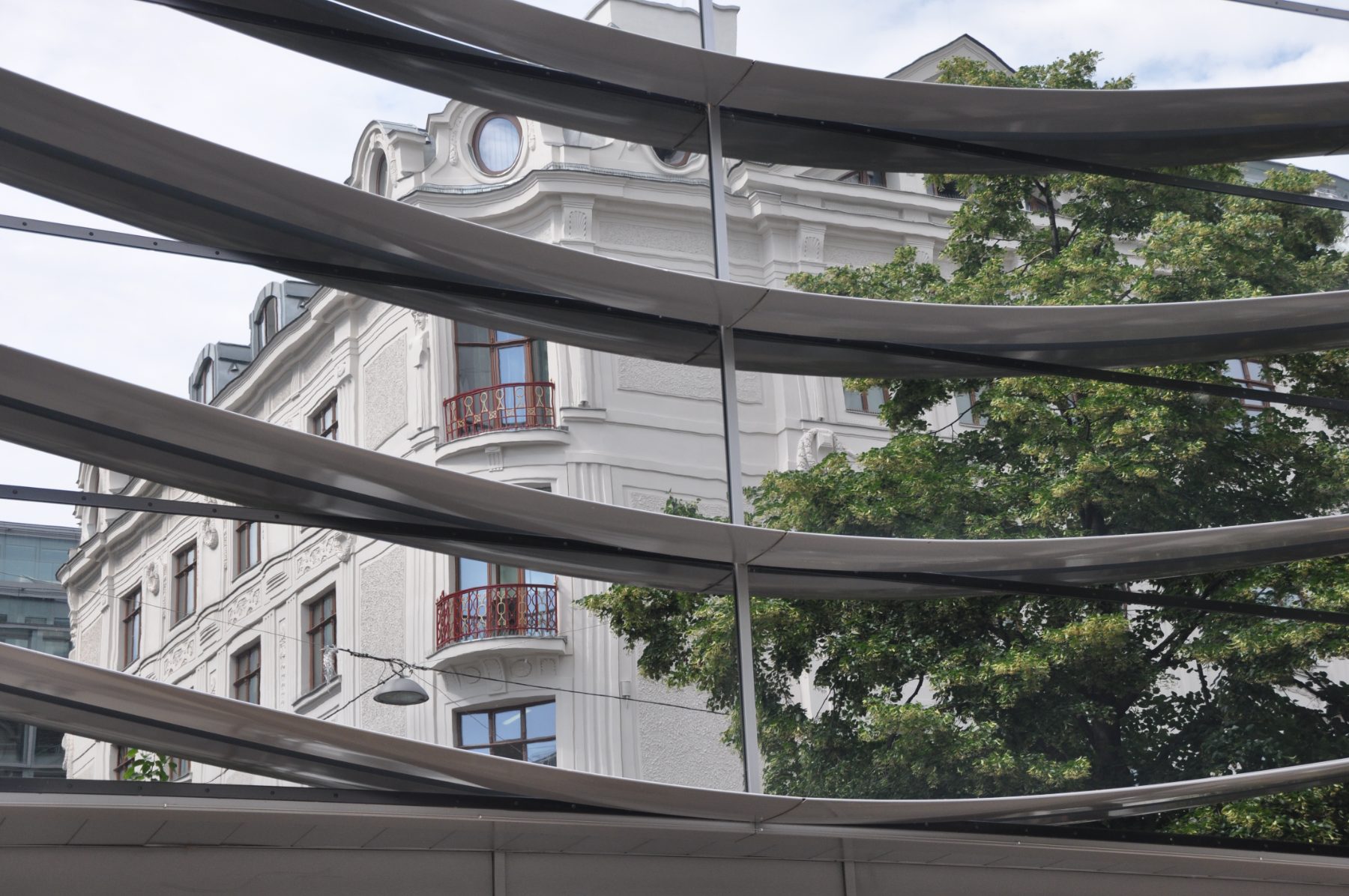 A Vienna facade seen through the slats of a modern awning